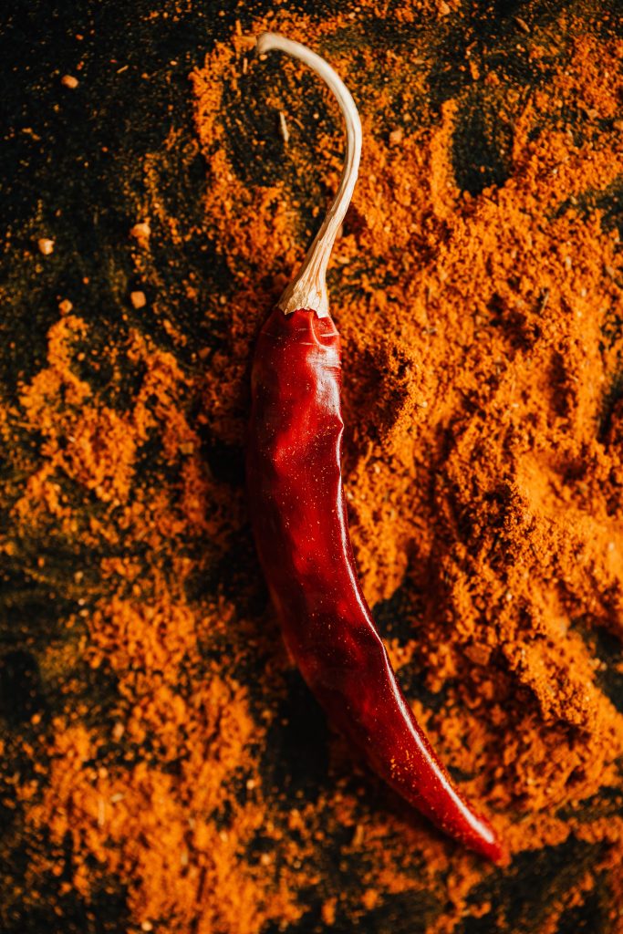 Red chilli pepper on powder of ground spices 4198417